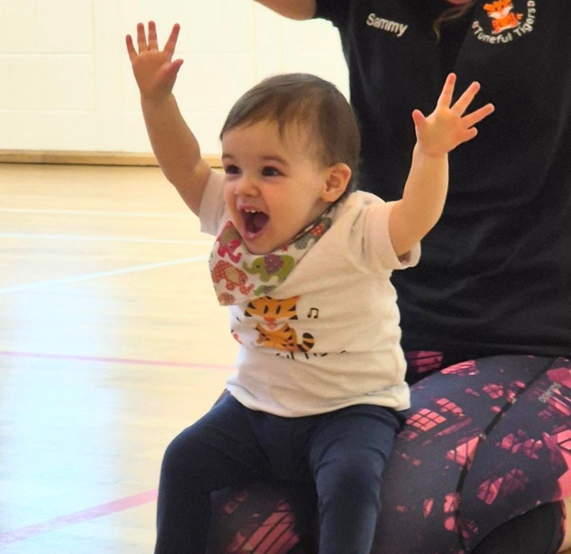 Toddler cheering during music class